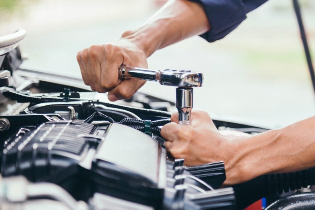 Automobile mechanic repairman hands repairing a car engine automotive workshop with a wrench, car service and maintenance,Repair service.